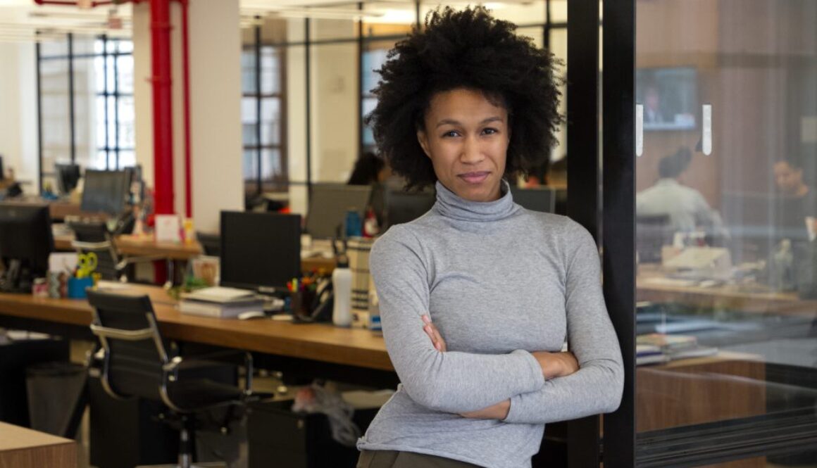 A black woman standing in an office.