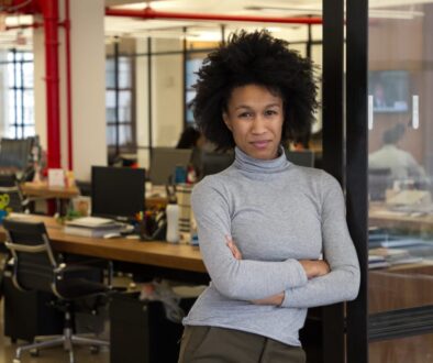 A black woman standing in an office.