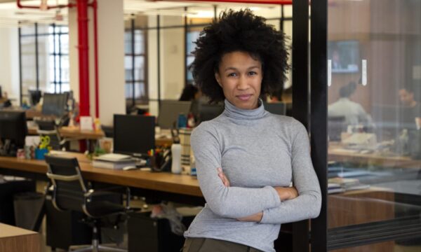 A black woman standing in an office.
