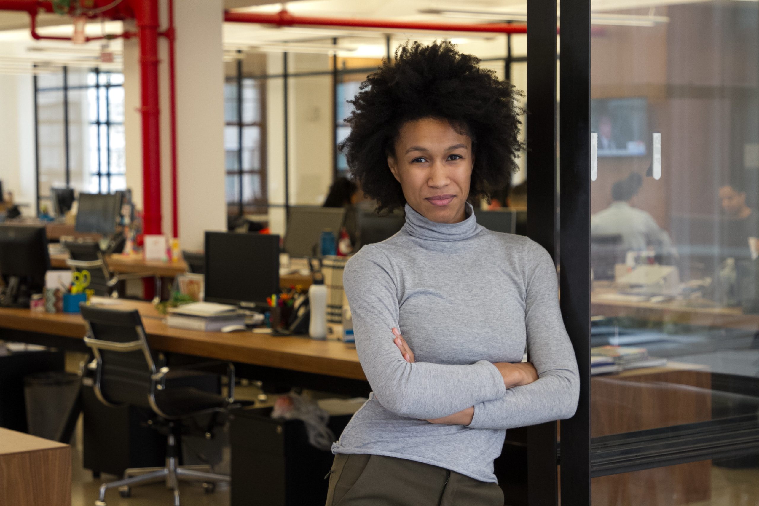 A black woman standing in an office.